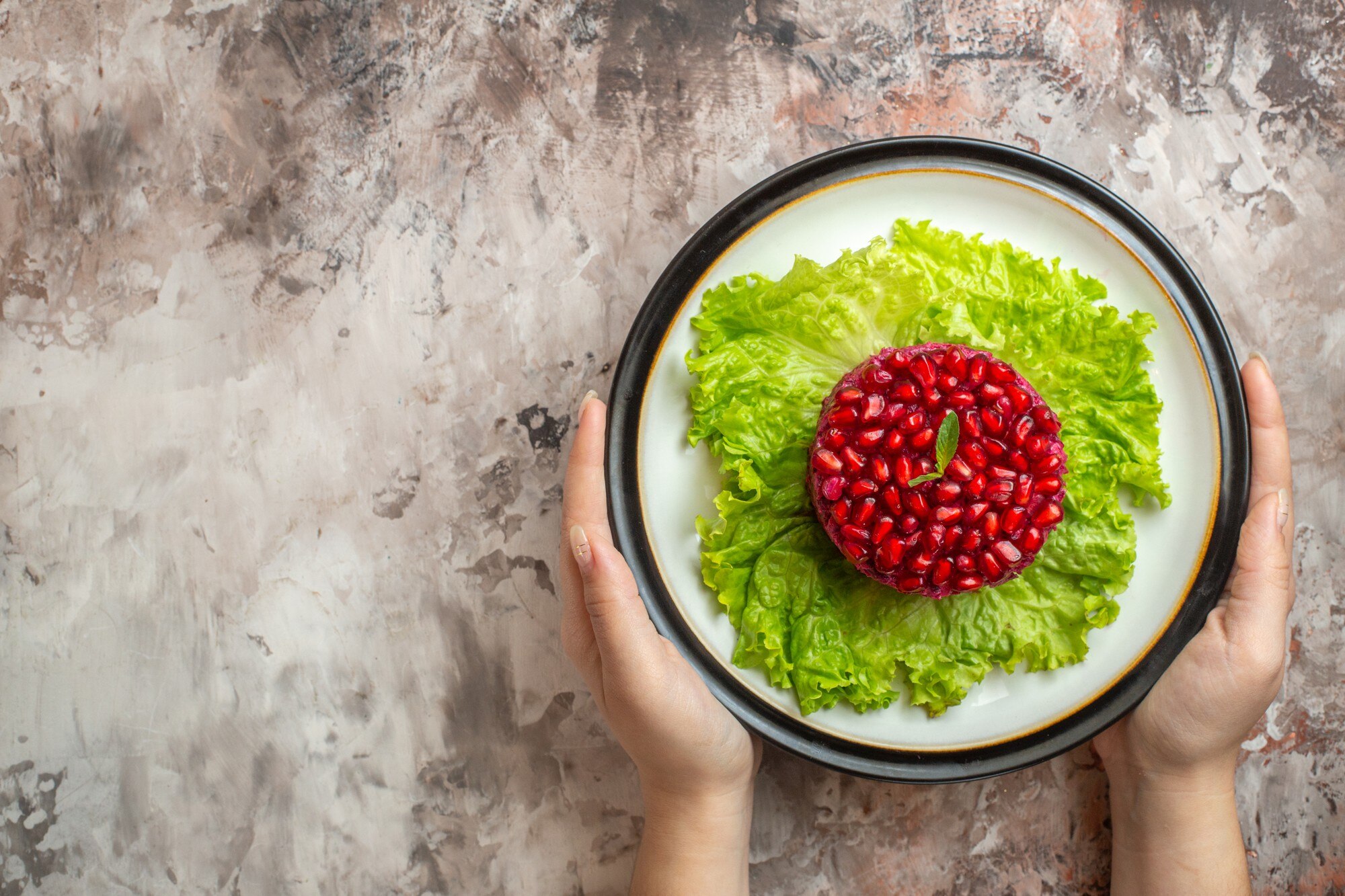 Persona sosteniendo un plato con alimentos coloridos y frescos, representando una dieta equilibrada